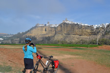 cyclist taking panoramic photo of Arcos