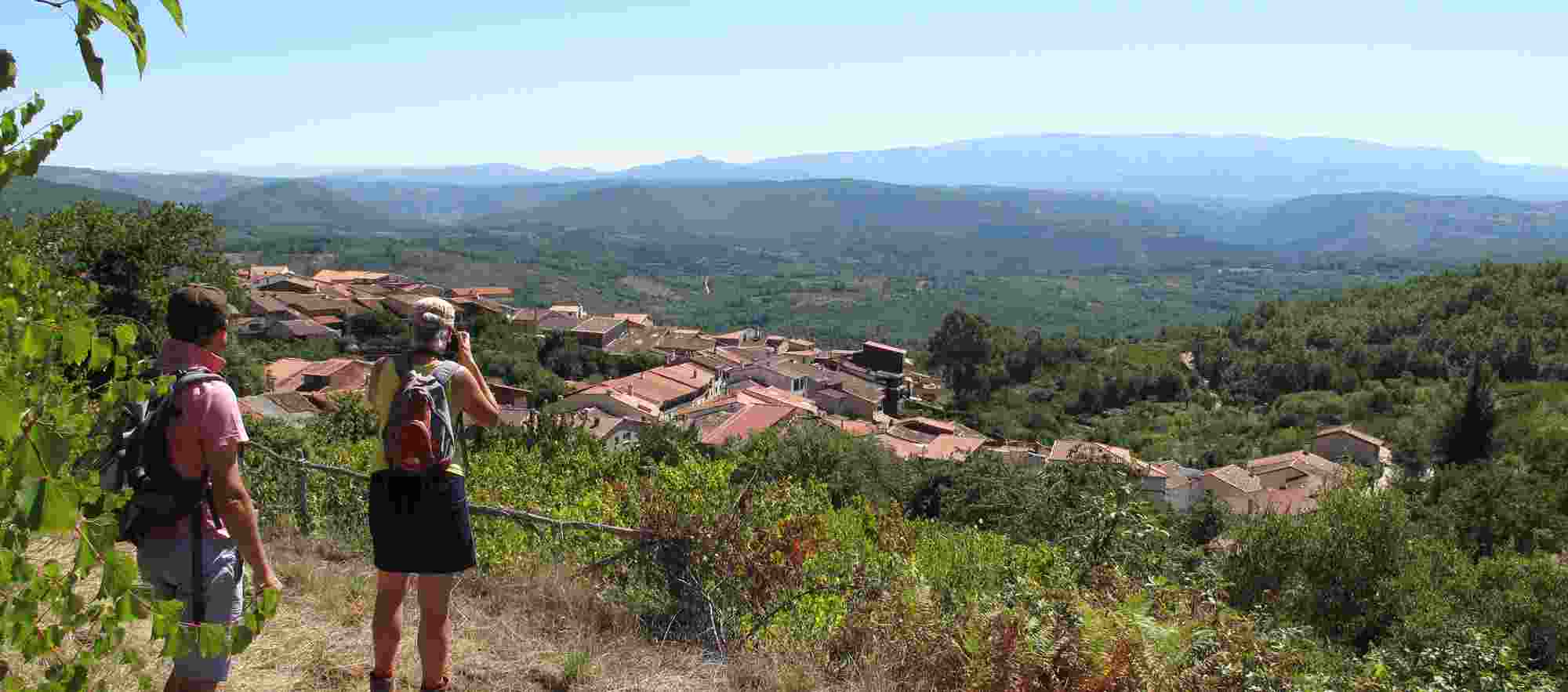Couple walking in Sierra de Francia admiring panorama